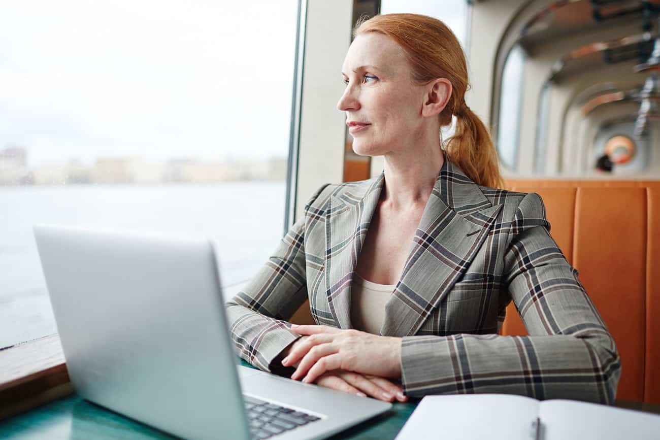 travel-void-remains-and-personal-grief-sets-in-for-this-woman-on-her-computer-while-on-the-train-because-of-result-of-a-poor-timeshare-investment