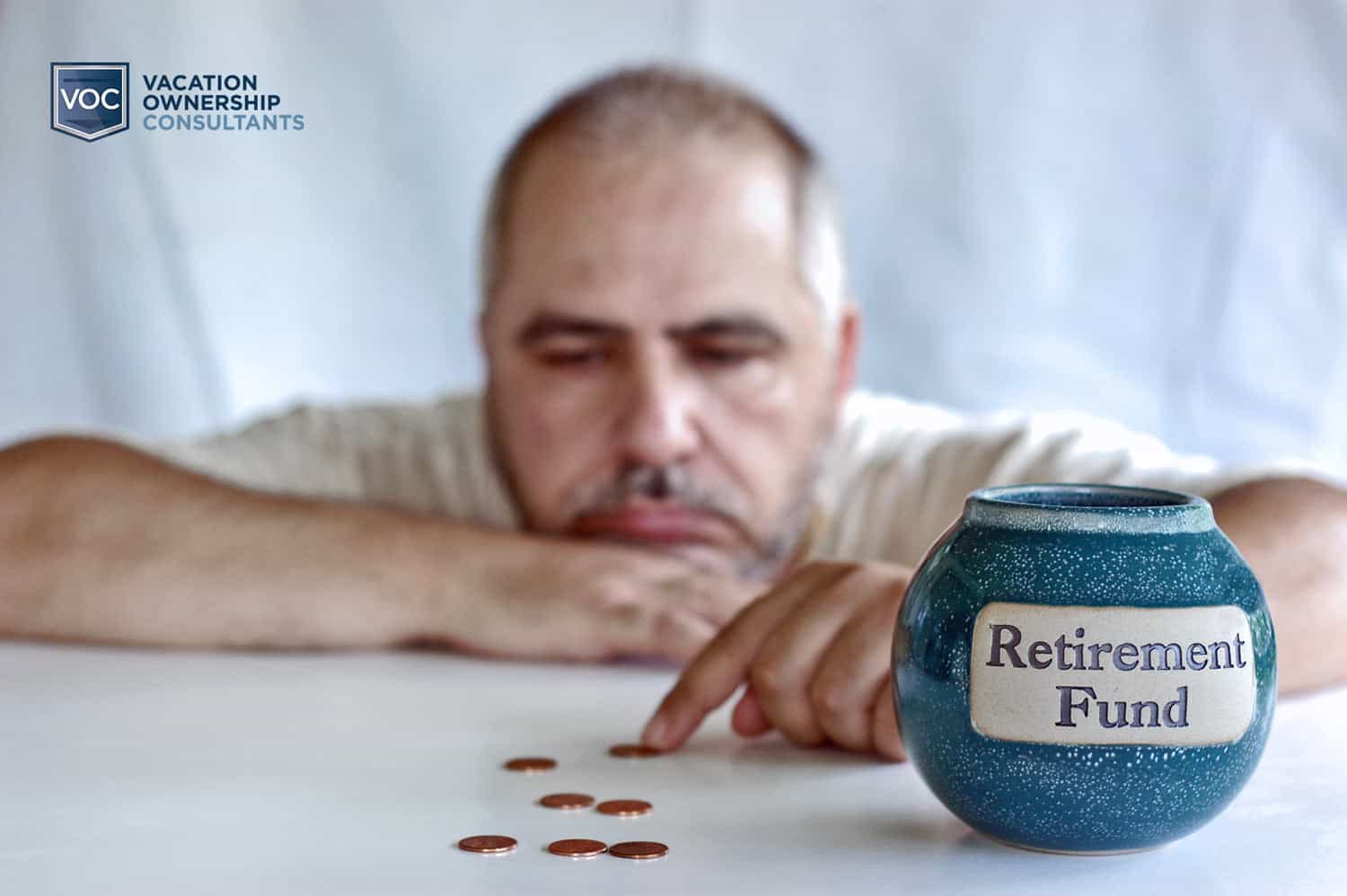 aging-man-counting-coins-at-desk-wishing-financial-burden-of-timeshare-contract-never-happened-so-he-could-save-for-retirement