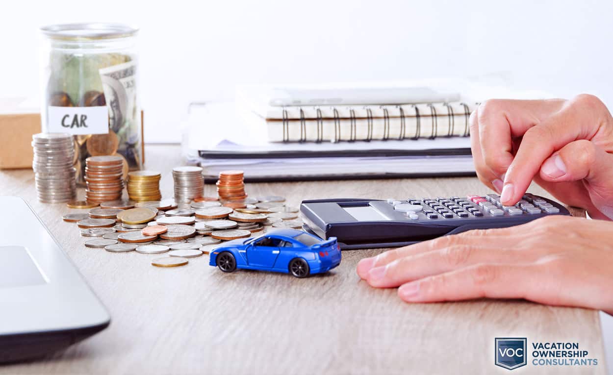 toy-car-on-desk-showing-purchase-of-new-vehicle-in-comparison-to-buying-vacation-property