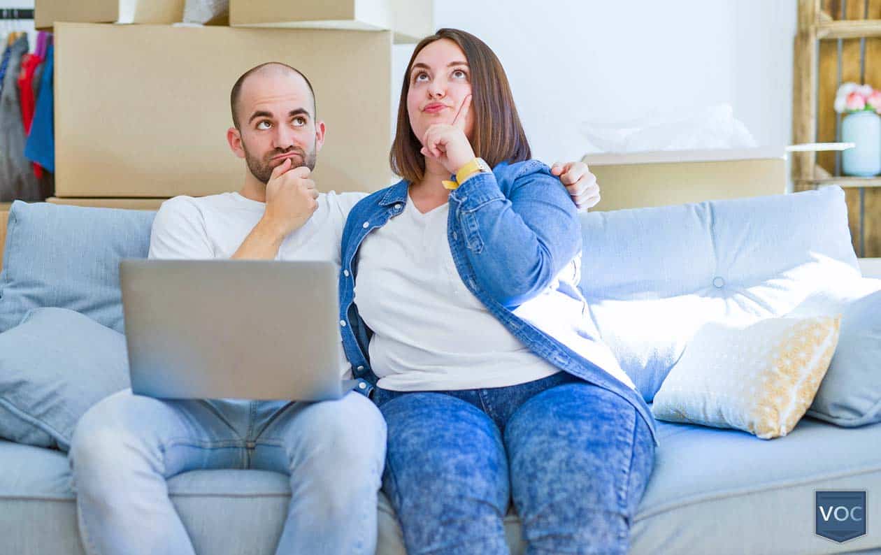 couple-sitting-on-couch-pondering-timeshare-advice-about-terminating-agreement-or-walking-away-from-purchase-altogether