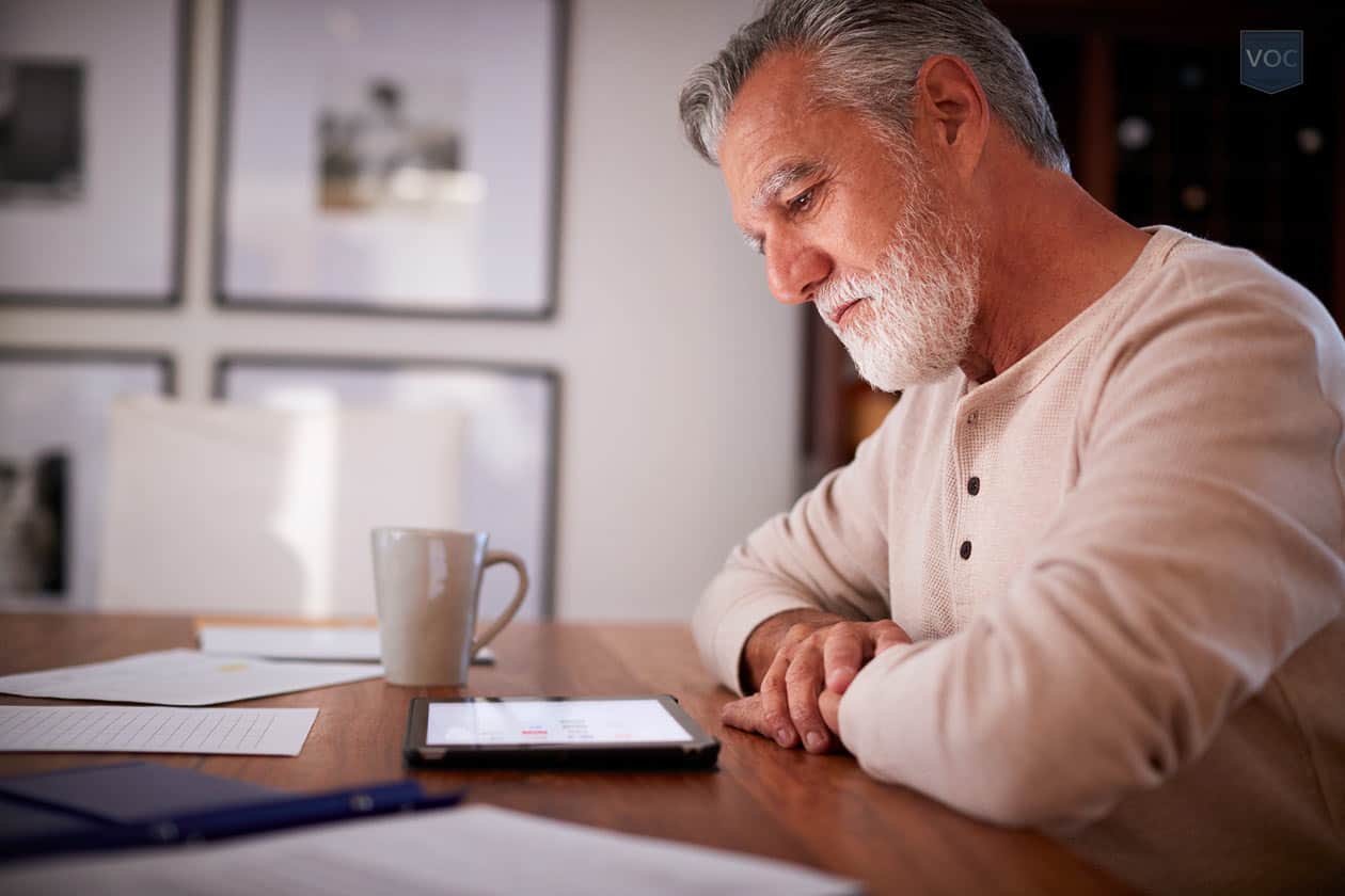 same-man-from-featured-image-looking-at-tablet-now-for-more-financial-options-regarding-fractional-ownership-as-he's-losing-money-on-his-travel-investment