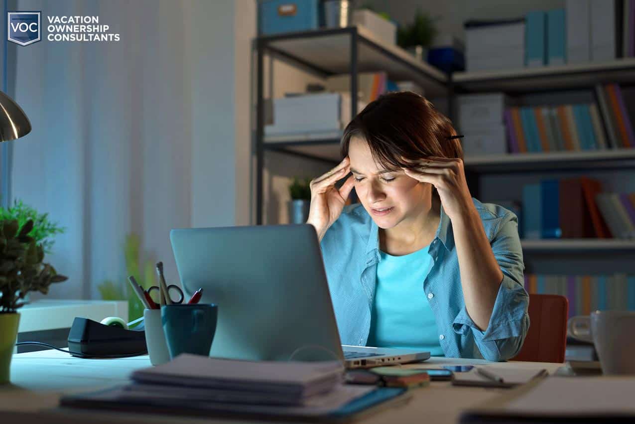 middle-aged-woman-at-laptop-thinking-about-ailiments-from-disease-and-impact-on-quality-of-life-and-productivity