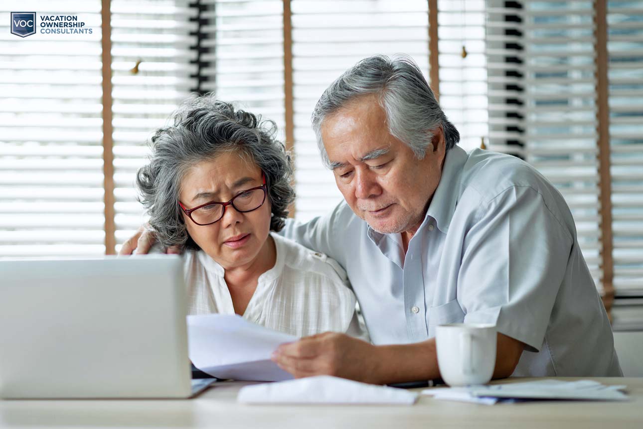 aged-couple-looking-at-computer-analyzing-timeshare-payments-during-down-season-and-travel-bans-across-america