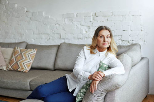 aging woman on couch alone