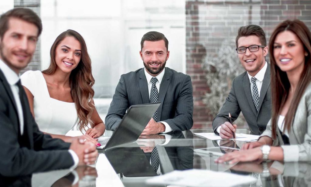 smiling-group-of-charisma-filled-timeshare-managers-seeming-trustworthy-but-devious-attractive-misleading-bunch-at-conference-room-table