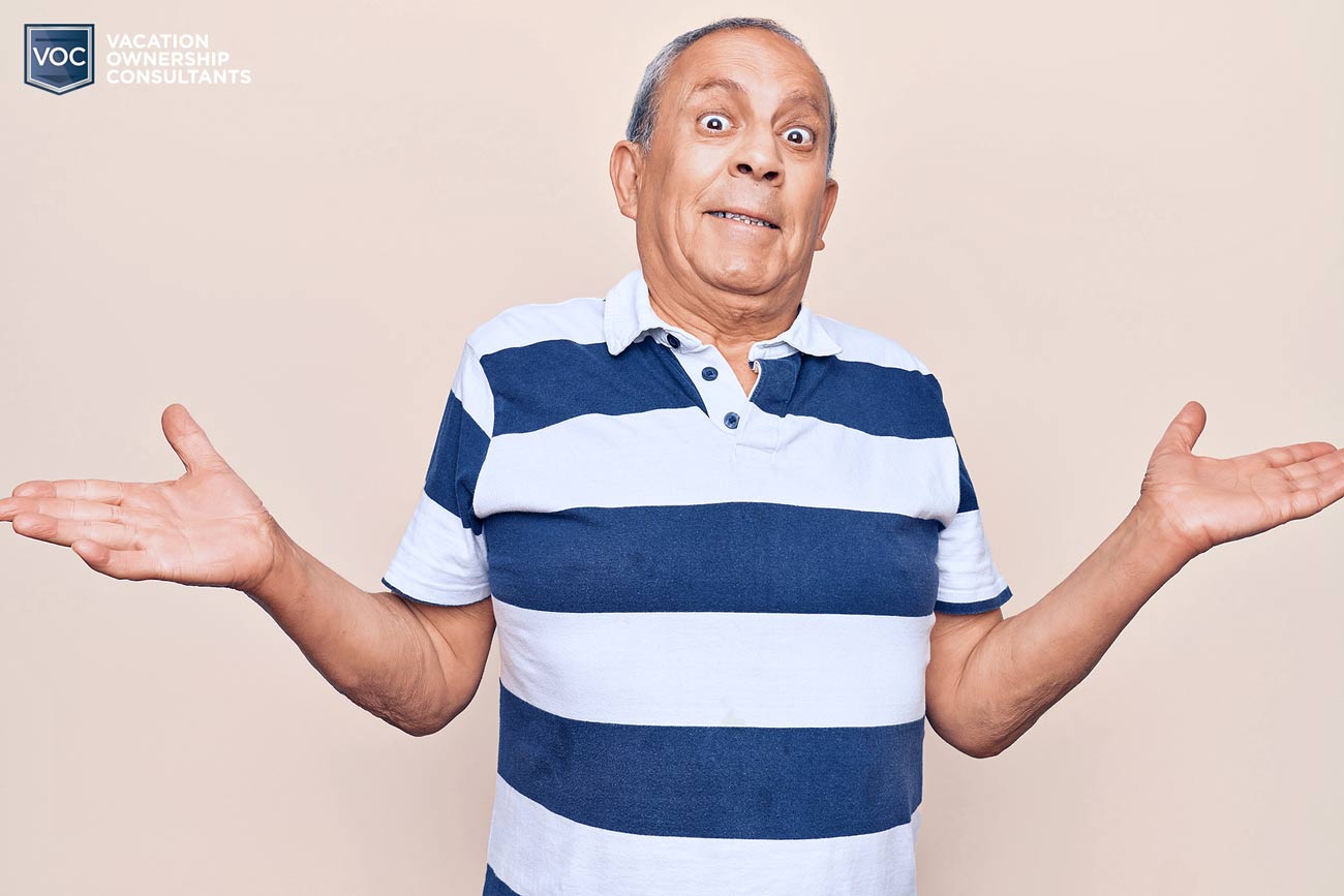 clueless-grandpa-going-with-flow-in-flt-background-striped-shirt-wide-eyed-during-timeshare-presentation